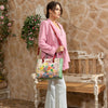 Woman in pink blazer carrying our Nicole Lee Dreams Blossom Tote in a modern background.