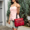 WOMEN IN A PINK SLEEVELESS TOP AND BLUE JEANS SHORT SMILING AWAY WITH OUR MARGOT TOTE IN RED SET IN A MODERN BACKGROUND.