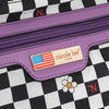 Close-up of purple zipper with brand label on checkered background