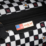 Spacious interior of Nicole Lee Family Yearbook zip backpack part of the Family Yearbook 3-in-1 set (backpack, crossbody, wallet)! Vegan leather with polyester interior and interior zip pocket with key strap to attach keys. Exclusively printed interior features a black and white checker print with flowers and NL monogram. 