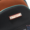 Close up detail of vegan leather Nicole Lee Family Yearbook zip backpack part of the Family Yearbook 3-in-1 set (backpack, crossbody, wallet). Gold-tone hardware logo engraved nameplate with diamond rhinestone studs. Textured vegan leather.