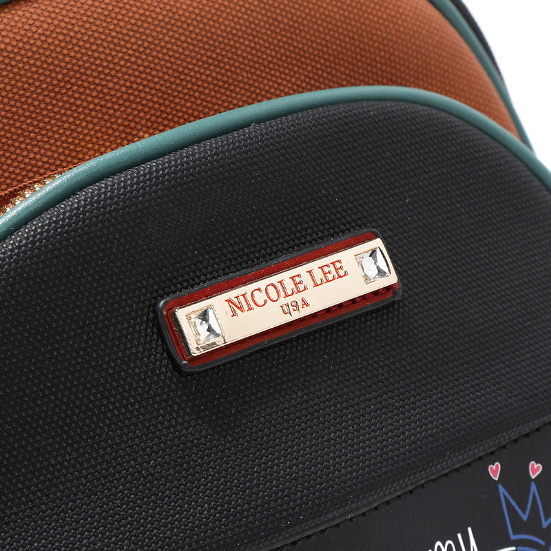 Close up detail of vegan leather Nicole Lee Family Yearbook zip backpack part of the Family Yearbook 3-in-1 set (backpack, crossbody, wallet). Gold-tone hardware logo engraved nameplate with diamond rhinestone studs. Textured vegan leather.
