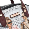 Close-up detail shot of vegan leather Ladies Night Out handbag part of the LADIES NIGHT OUT 3 PIECE SET (Handbag, Crossbody, Wallet). Two stylish ladies getting ready to go out with coffee in their hands and chic, fashionable outfits. Gold-tone hardware and maroon vegan leather dual handles. 
