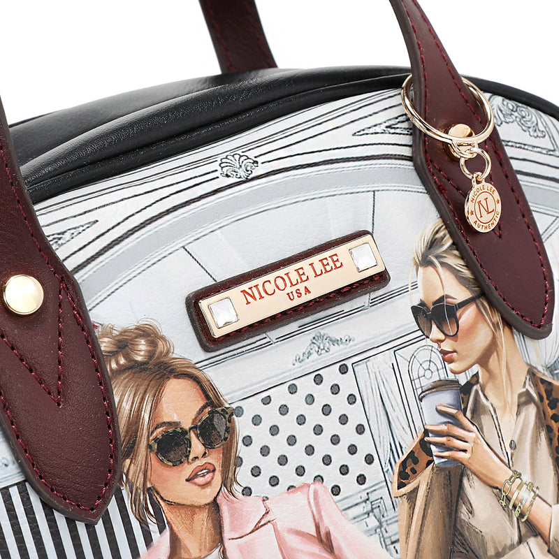 Close-up detail shot of vegan leather Ladies Night Out handbag part of the LADIES NIGHT OUT 3 PIECE SET (Handbag, Crossbody, Wallet). Two stylish ladies getting ready to go out with coffee in their hands and chic, fashionable outfits. Gold-tone hardware and maroon vegan leather dual handles. 