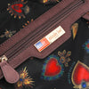 Close up interior shot of the Queen vegan leather structured handbag interior, part of THE QUEEN 3 PIECE SET (Handbag, Crossbody, Wallet). Back interior zip pocket with vegan leather accents and logo engraved gold-tone nameplate with american flag. 