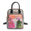 Nicole Lee vegan leather Violet Blossoms backpack, part of the VIOLET BLOSSOM 3 PIECE SET (Backpack, Crossbody, Wallet). Illustration of pink and white tulips against a Nicole Lee branded dust bag and hot pink structured chain link bag. Dual top handles and dual shoulder straps with logo-engraved gold-tone nameplate with diamond rhinestones. Main zip top closure with side slip pockets and additional front zip compartment. 