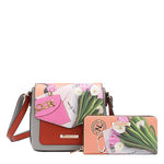 Nicole Lee vegan leather Violet Blossoms flap crossbody paired with the matching Violet Blossom zip wallet, part of the VIOLET BLOSSOM 3 PIECE SET (Backpack, Crossbody, Wallet). Illustration of pink and white tulips against a Nicole Lee branded dust bag and hot pink structured chain link bag. 