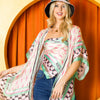 woman wearing our printed kimono and blue jeans and our printed hat set on a orange background.