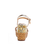 The platform wedge is adorned with gold yellow rhinestones and  braid detailing.