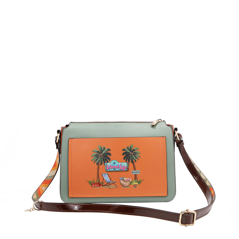 Our Sun and Sand Crossbody bag with palm tree design on an orange background with straps