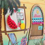 Our Sun and Sand Tropical-themed door with 'Life is Better at the Beach' sign, watermelon, pineapple, and deck chair.