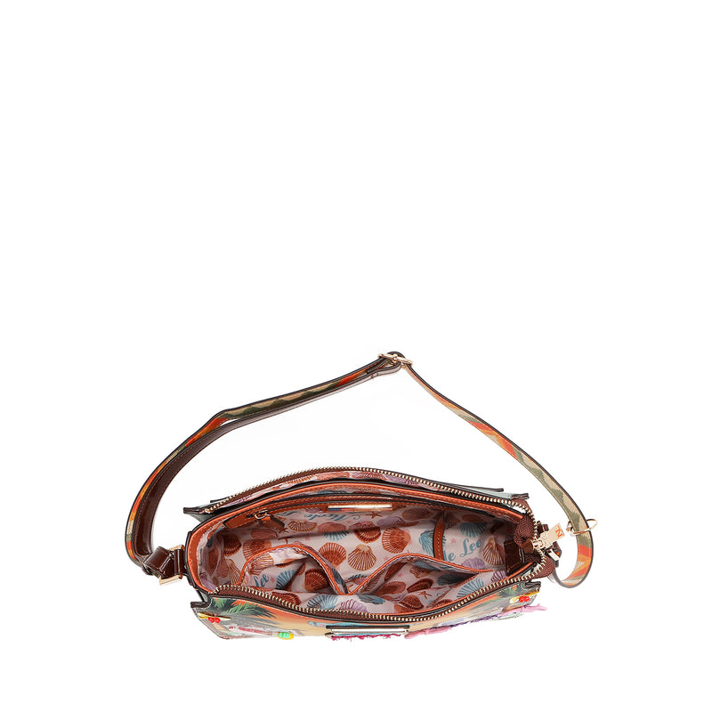 Our sun and Sand Crossbody bag with shells lining set on a white background
