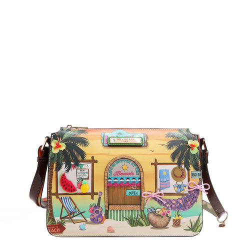 Our Sun and Sand Crossbody bag with a tropical design featuring a beach hut, palm trees, and beach items set on a white background.