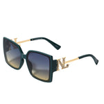 OUR GREEN SQUARE SUNGLASSES. NICOLE LEE RHINESTONE LOGO ON THE SIDES OF THE FRAMES.